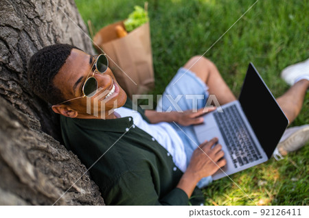 Top view of man with laptop smiling at camera 92126411