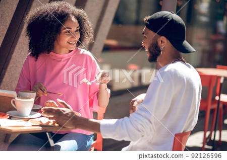 Cute young couple having coffee in the cafe Cute young couple having coffee in the cafe 92126596