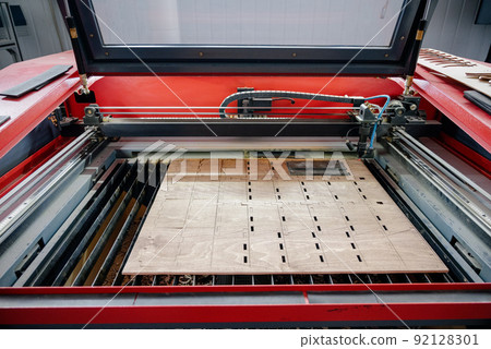 Laser cutting beam over plywood sheet Laser cutting beam over plywood sheet 92128301