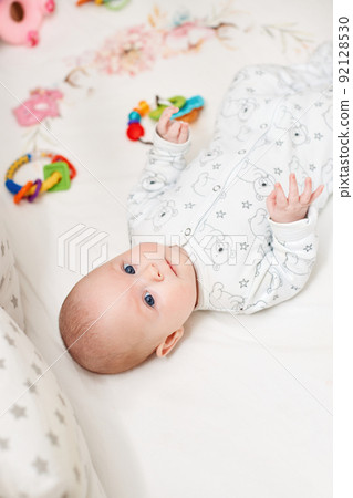 happy newborn baby in crib at home 92128530