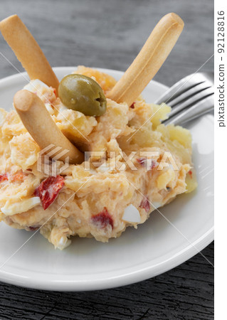 Tapa typical of Spain, Russian potato salad, egg, tuna and olives Tapa typical of Spain, Russian potato salad, egg, tuna and olives 92128816