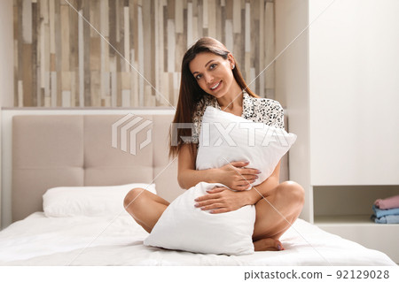 Beautiful woman with soft pillow at home. Bedtime Beautiful woman with soft pillow at home. Bedtime 92129028
