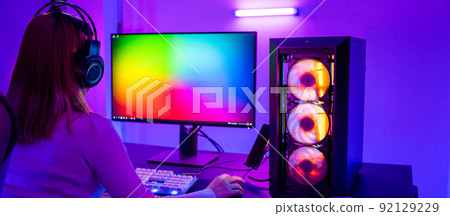 Asian professional gamer playing online video game on desktop computer PC have colorful neon LED lights 92129229