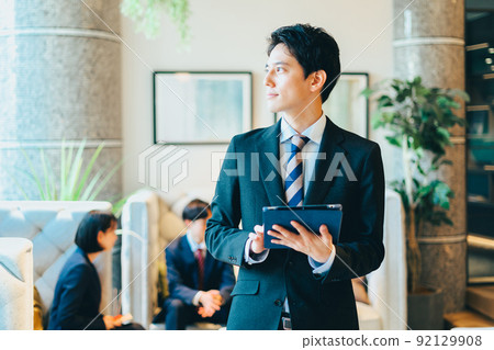 A businessman with a tablet 92129908