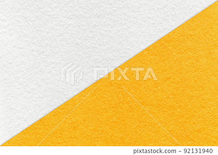 Texture of craft white and yellow paper background, half two colors, macro. Vintage dense kraft orange cardboard. 92131940