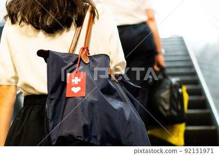 Image of a woman with a help mark commuting to work 92131971