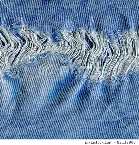 Hole and threads on denim jeans Hole and threads on denim jeans 92132906