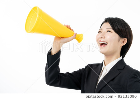 Female new employee screaming with a yellow megaphone on a white background 92133090