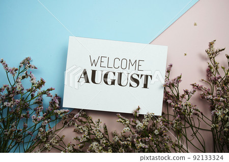 Welcome August text message with flower on blue and pink background 92133324