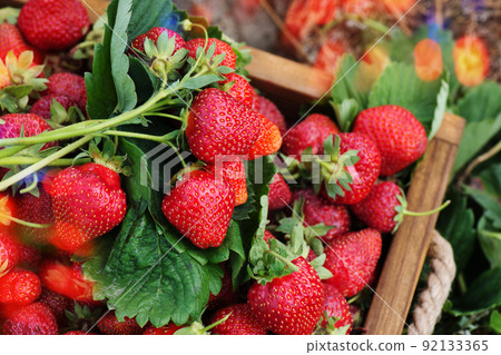 Organic ripe strawberries in a wooden basket 92133365