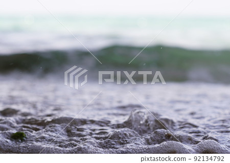 Sandy beach and waves 92134792