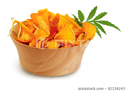 petals of fresh marigold or tagetes erecta flower in wooden bowl isolated on white background with full depth of field. petals of fresh marigold or tagetes erecta flower in wooden bowl isolated on white background with full depth of field. 92136243
