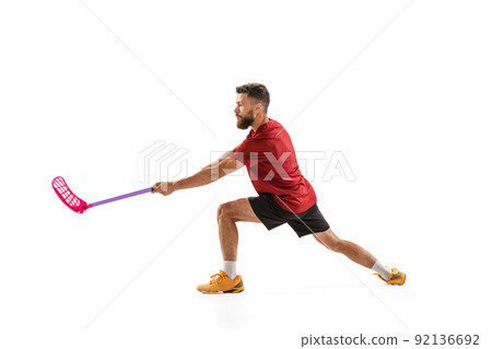 Dynamic portrait of male floorball player with floorball stick in action isolated on white background. Sport, competition and motion, movement, active lifestyle 92136692
