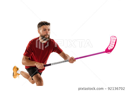 Dynamic portrait of male floorball player with floorball stick in action isolated on white background. Sport, competition and motion, movement, active lifestyle 92136702