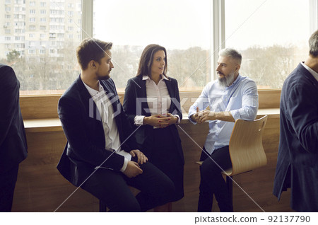 Various colleagues communicate and discuss information after business event or corporate training. 92137790