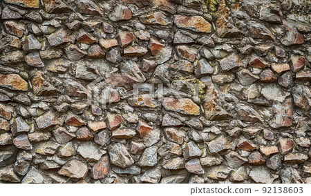 old stone wall close up of brown and gray cobblestones 92138603