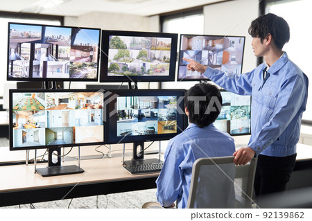 Security guard checking the video of the surveillance camera 92139862