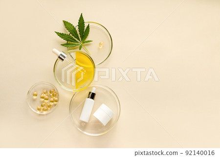 Skin care cosmetics with CBD oil and cannabis in a white mock-up package Skin care cosmetics with CBD oil and cannabis in a white mock-up package 92140016