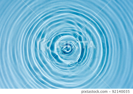 Texture of blue water with rings and ripples from drops Texture of blue water with rings and ripples from drops 92140035