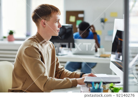 Programmer working in software developing company Programmer working in software developing company 92140276