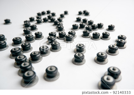 Repair of winter studded tires. Repaired spikes scattered on a white background. Replaced lost car tire spikes. 92140333