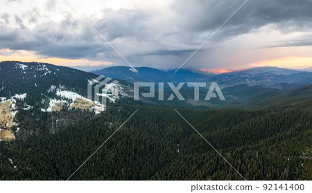 Carpathian village between the mountain tops, dawn in the mountains, panorama of the village in the mountains. 92141400
