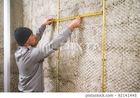 measuring the distance between the guide metal beacons, metal beacons attached to a wooden wall. 92141448