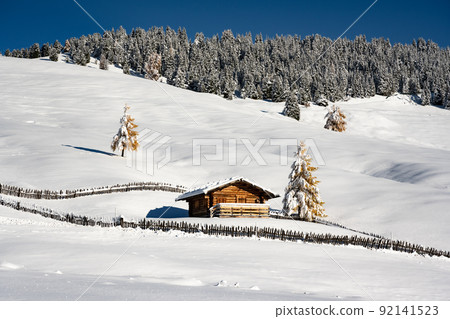 Picturesque landscape with small wooden house on meadow Alpe di Siusi Picturesque landscape with small wooden house on meadow Alpe di Siusi 92141523
