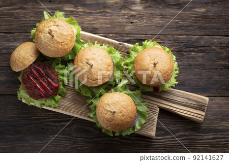 Fresh tasty burgers with juicy meat patties Fresh tasty burgers with juicy meat patties 92141627