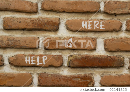 Help is here and support symbol. Concept words Help is here on brick wall. Beautiful brick wall background. Business support and help is here quote concept. Copy space. 92141823