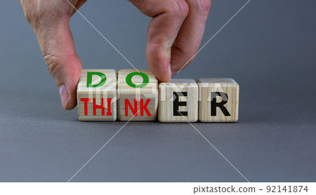 Doer or thinker symbol. Concept words Doer or thinker on wooden cubes. Businessman hand. Beautiful grey table grey background. Business and doer or thinker concept. Copy space. 92141874