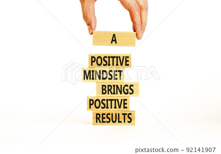 Positive mindset symbol. Wood blocks with words A positive mindset brings positive results. Beautiful white background Businessman hand. Business motivational positive mindset concept. Copy space. 92141907
