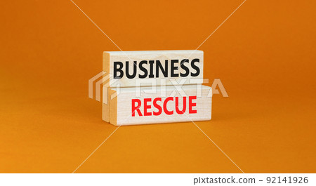 Business rescue symbol. Concept words Business rescue on wooden blocks on a beautiful orange table orange background. Business rescue and support concept. Copy space. 92141926