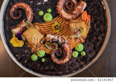 Octopus with potatoes on pea mash 92141967