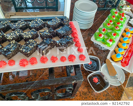 mouth-watering colorful desserts at the hotel for lunch. sweets for tourists. assorted pastries and cakes in glaze, chocolate pies, cream of sweets mouth-watering colorful desserts at the hotel for lunch. sweets for tourists. assorted pastries and cakes in glaze, chocolate pies, cream of sweets 92142792