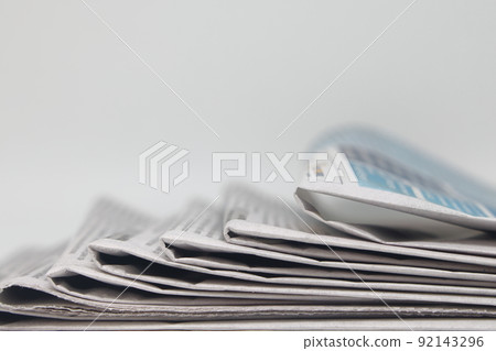 Rolled up stack of fresh newspapers, news, printed background. 92143296
