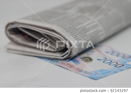 Rolled up stack of newspapers, banknotes stuck between newspapers, news, fake news, corrupt press. Rolled up stack of newspapers, banknotes stuck between newspapers, news, fake news, corrupt press. 92143297