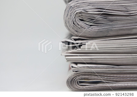 Rolled up stack of fresh newspapers, news, printed background. 92143298