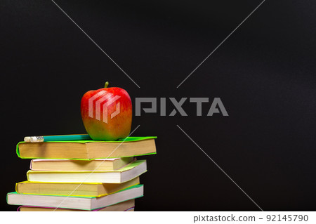 red apple and old books on wooden tabletop red apple and old books on wooden tabletop 92145790