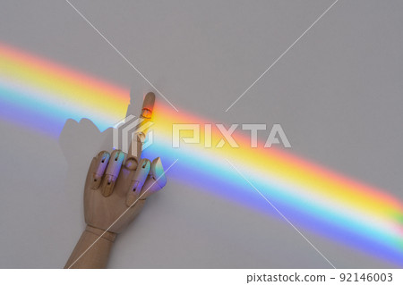 Hand showing fuck gesture on LGBT community rainbow flag background 92146003