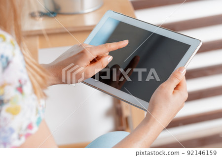 woman holding digital tablet, closeup 92146159