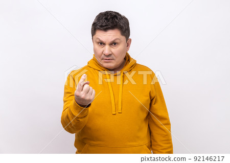 Come to me. Portrait of middle aged handsome man making beckoning gesture and looking at camera with alluring eyes, wearing urban style hoodie. Indoor studio shot isolated on white background. 92146217