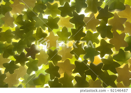 Candy pattern. silhouette of many multi colored yummy bright candies in different star shapes. 92146487