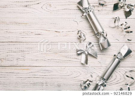 Christmas crackers with shiny confetti on color background, top view, copy space Christmas crackers with shiny confetti on color background, top view, copy space 92146829