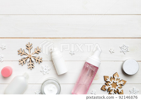 Makeup products and Christmas decorations on color background. Top view New year Beauty concept with copy space 92146876