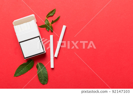 Pack of menthol cigarettes and fresh mint on colored table, Menthol cigarettes top view flat lay 92147103