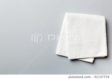 Top view of white towels with copy space on colored background 92147759