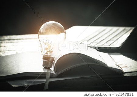 Light bulbs and book opening on wooden table.Creative thinking ideas for work on desk. 92147831