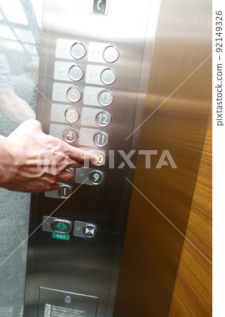 Hand pressing the button on the 10th floor of the elevator Hand pressing the button on the 10th floor of the elevator 92149326