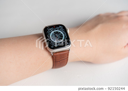 Wearable device wrapped around a woman's arm Brown leather belt watch Wearable device wrapped around a woman's arm Brown leather belt watch 92150244